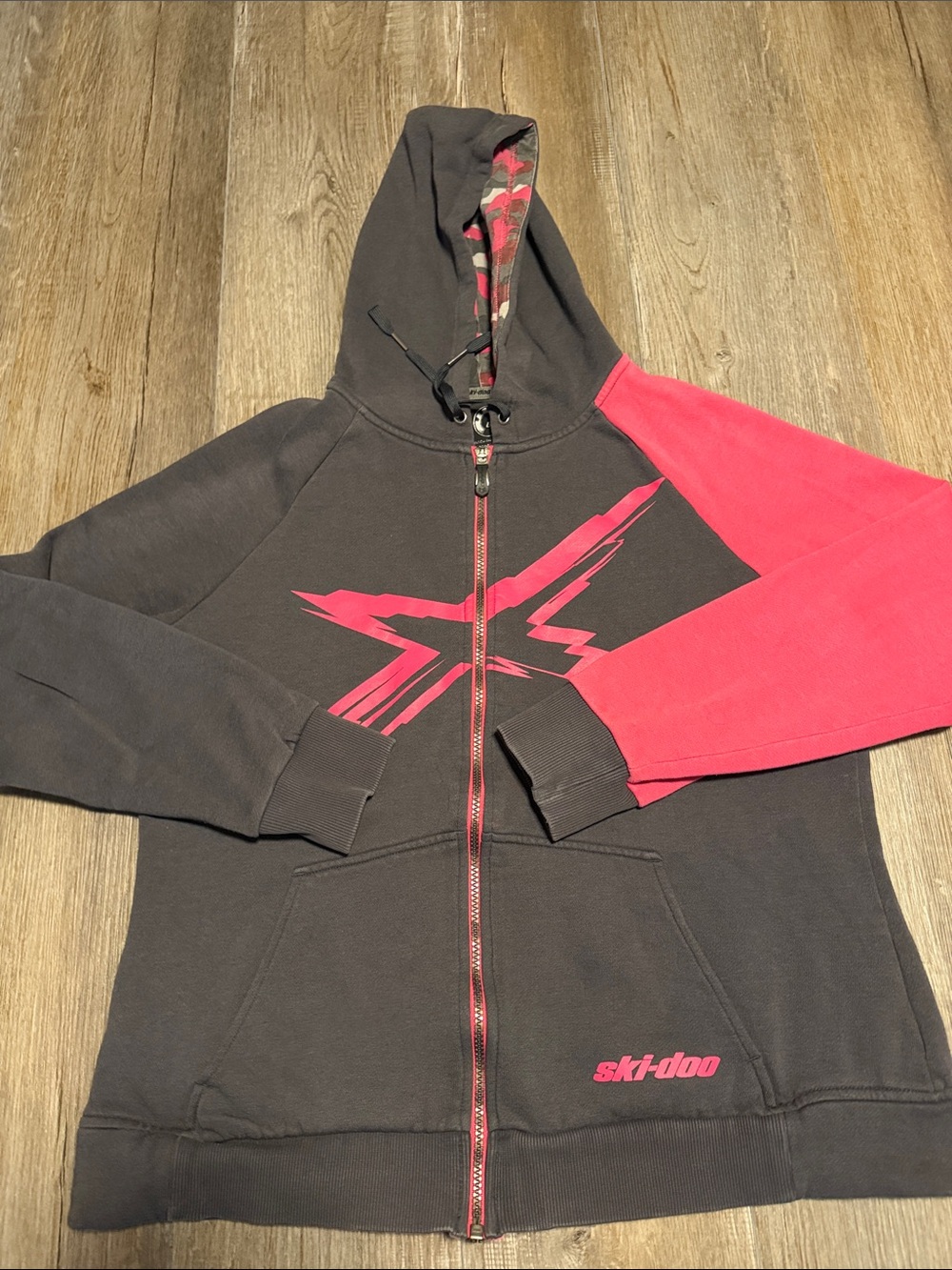 BRP Ski-Doo zip-up hoodie featuring a vibrant pinkish-red X-team graphic